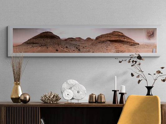 Framed panoramic Mars landscape poster from the Curiosity Rover, displayed above a wooden console with gold accents, artistic decor, and a yellow chair in a modern interior.