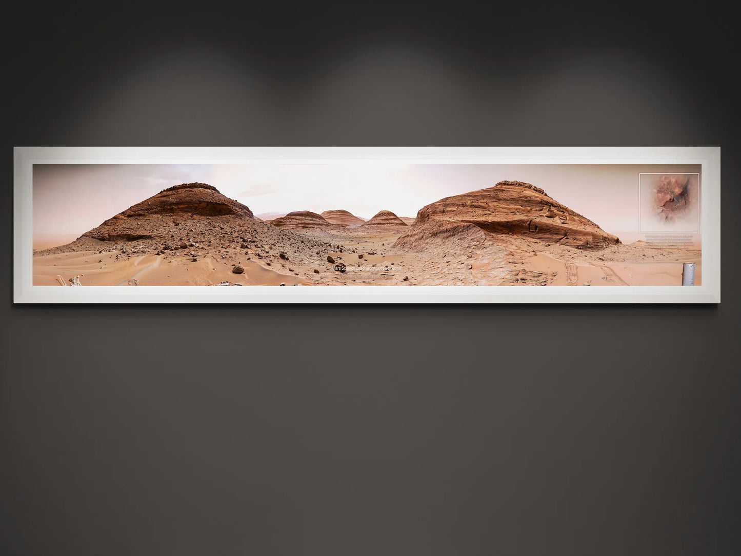 Panoramic Mars poster featuring rocky terrain and formations photographed by the Curiosity Rover, framed and displayed on a dark wall.
