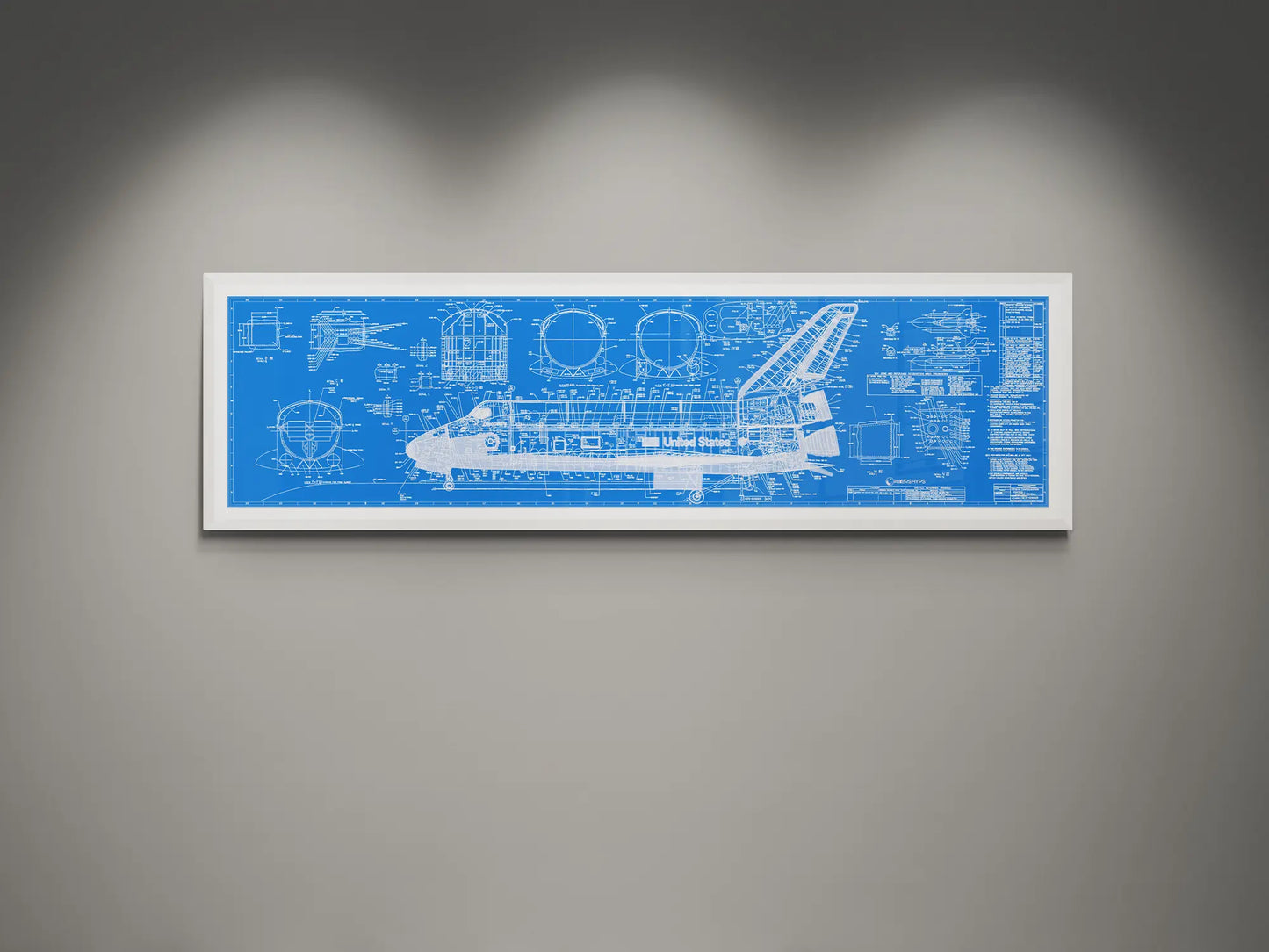 Framed NASA space shuttle blueprint wall art featuring detailed white engineering schematics and technical diagrams on a blue white background, displayed on a modern gray wall.