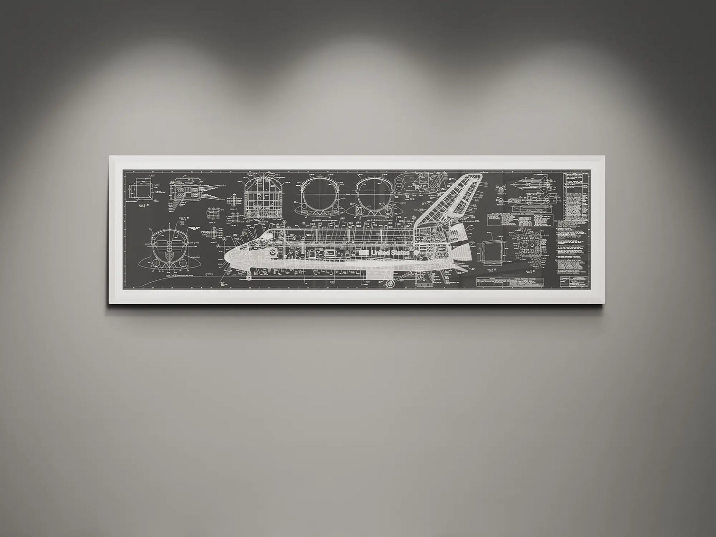 Framed NASA space shuttle blueprint wall art featuring detailed white engineering schematics and technical diagrams on a charcoal background, displayed on a modern gray wall.