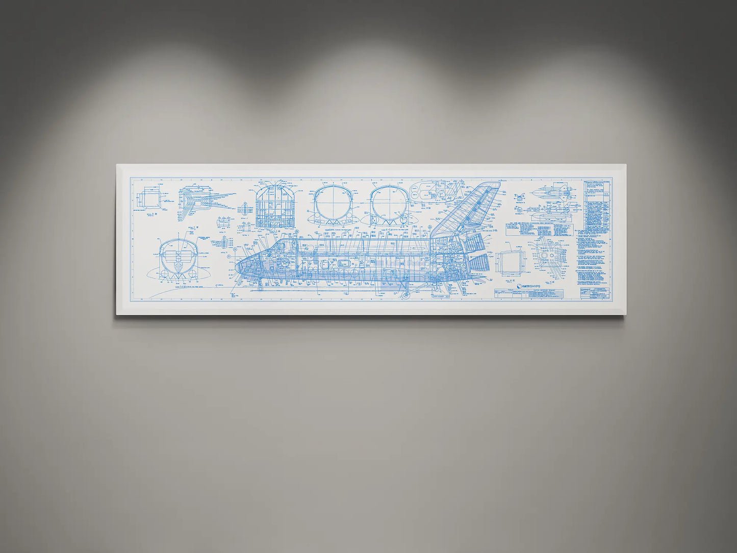 Framed NASA space shuttle blueprint wall art featuring detailed white engineering schematics and technical diagrams on a white background, displayed on a modern gray wall.