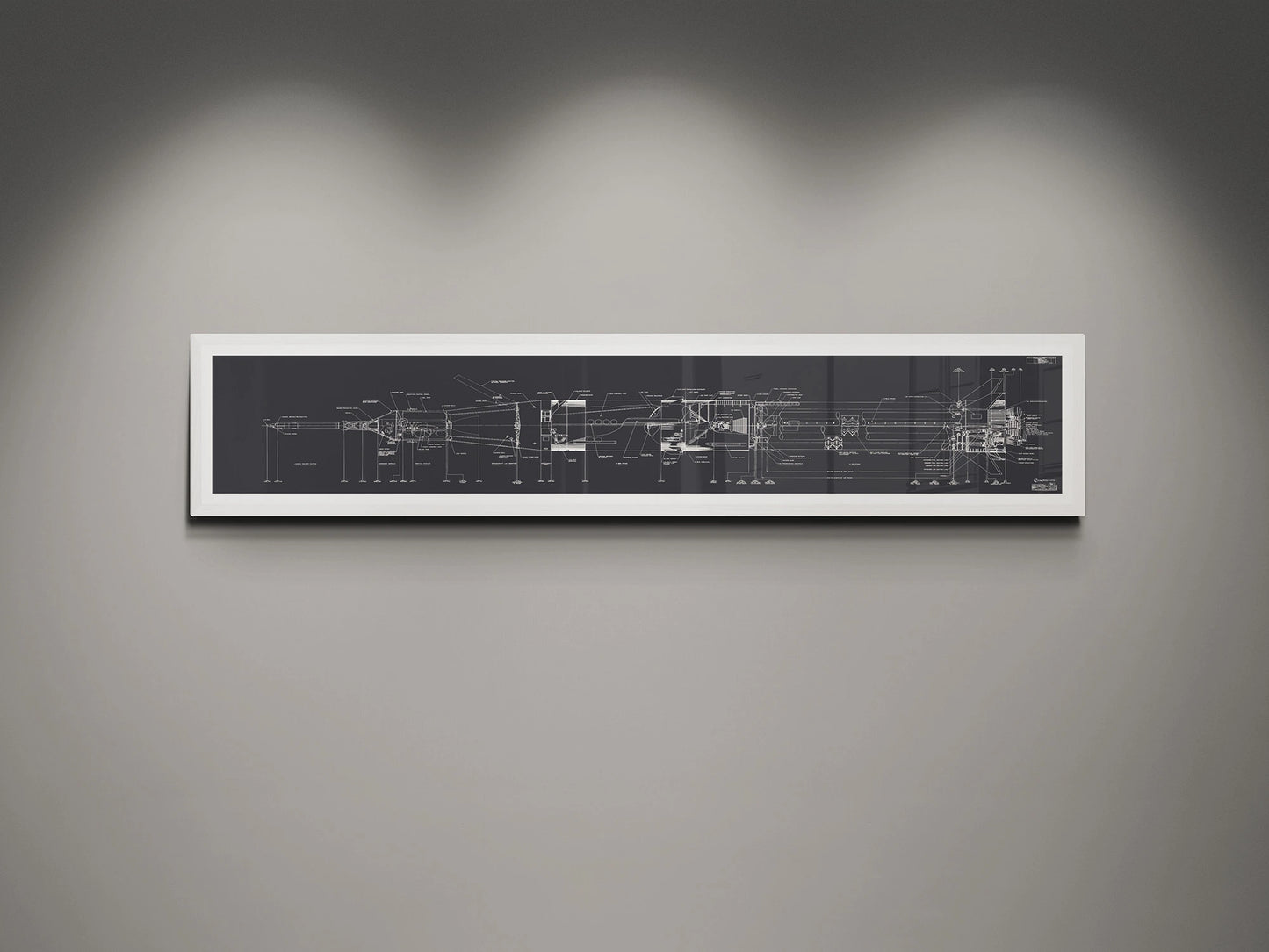 Apollo Saturn 1B Blueprint | NASA posters | Technical blueprint Diagram | A detailed blueprint of the NASA Saturn IB rocket displayed in a white frame against a gray wall. The blueprint features technical schematics in white on a charcoal background, illuminated by subtle overhead lighting.