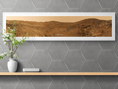 Minimalist interior design featuring a framed panoramic Mars poster from the Spirit Rover, displayed on a wooden shelf with a vase of blooming white flowers and a hexagonal tile backdrop.