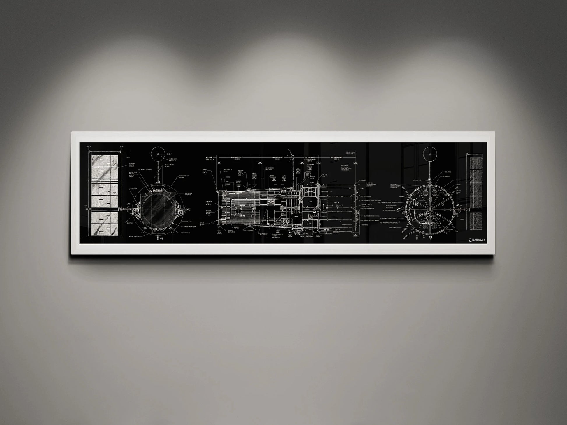 Hubble Space Telescope Blueprint | Rocket Blueprint Posters | A framed blueprint of the NASA Hubble Space Telescope, showcasing intricate technical drawings in white on a black background. The blueprint is mounted on a gray wall and highlighted by soft overhead lights.
