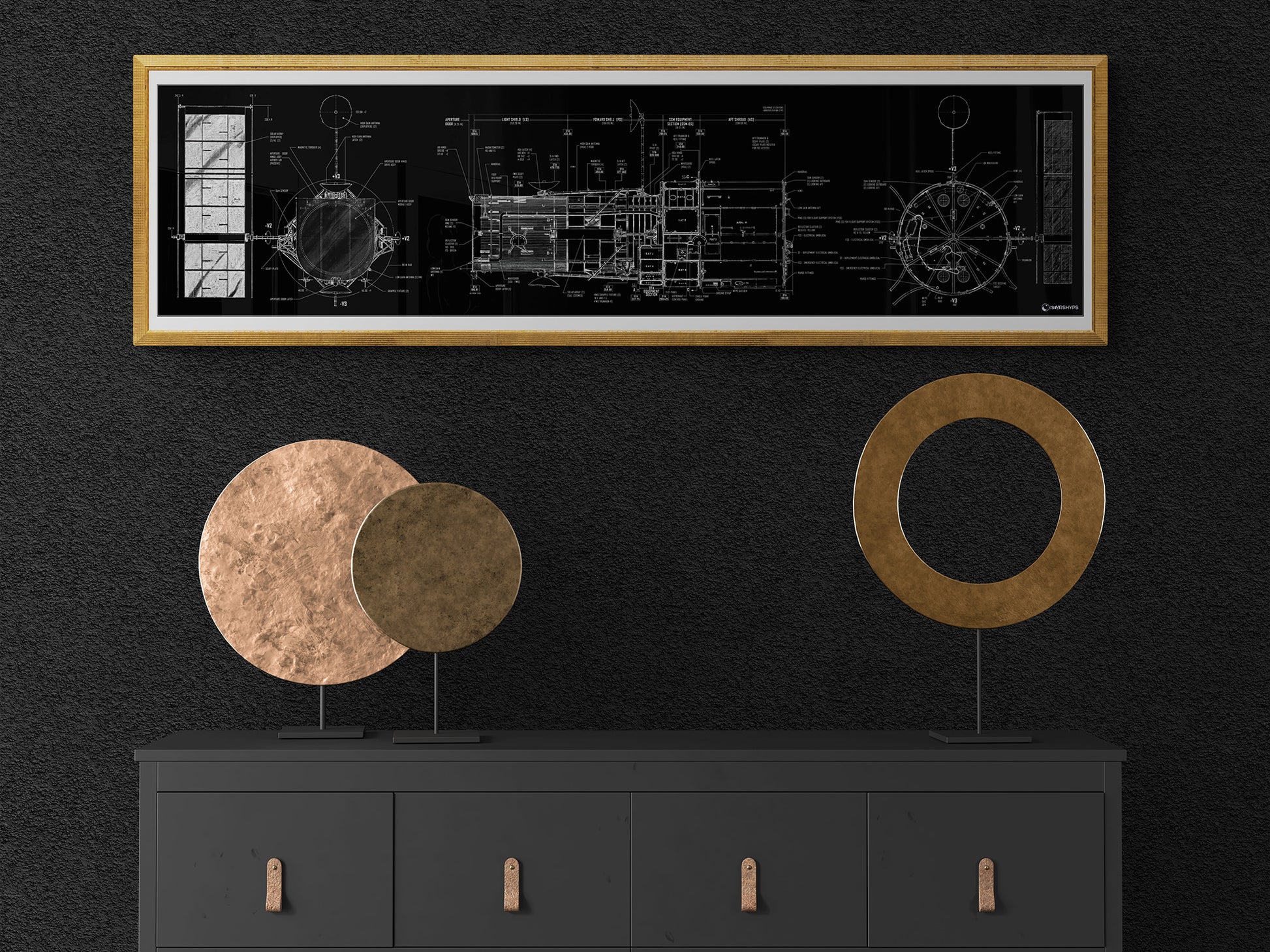 Hubble Space Telescope Blueprint | Rocket Blueprint Posters | A technical blueprint of the Hubble Space Telescope, encased in a gold frame, is showcased on a black wall above a minimalist black dresser. The dresser features two circular decorative pieces in gold and copper.