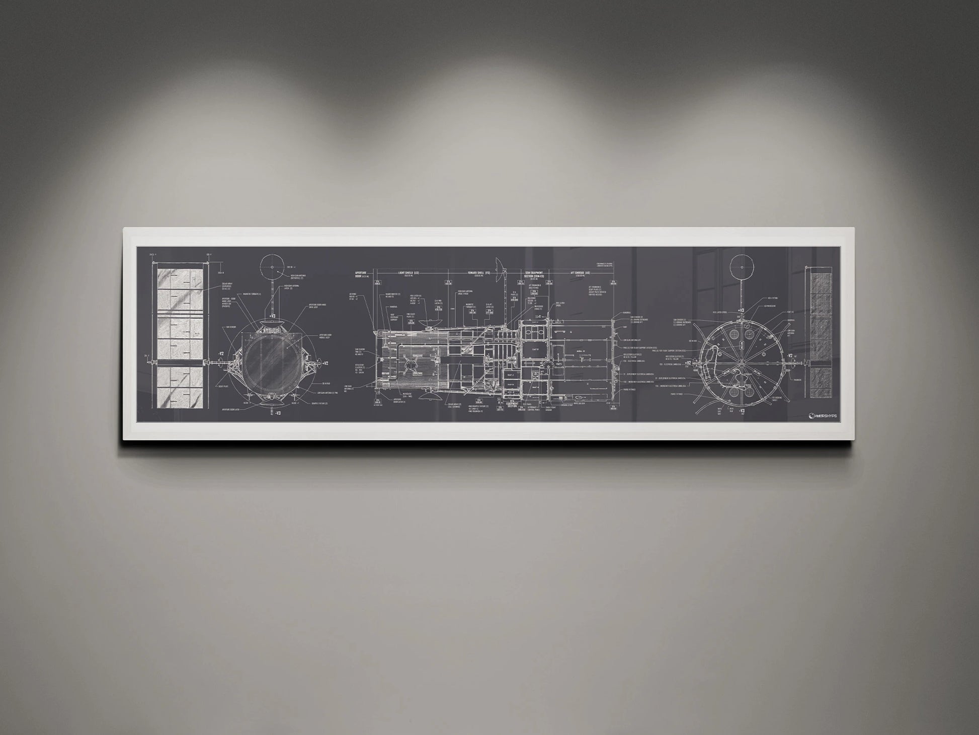 Hubble Space Telescope Blueprint | Rocket Blueprint Posters | A white-framed detailed blueprint of the NASA Hubble Space Telescope, showcasing technical schematics in white on a charcoal background. The blueprint is displayed on a gray wall, illuminated by soft overhead lights.