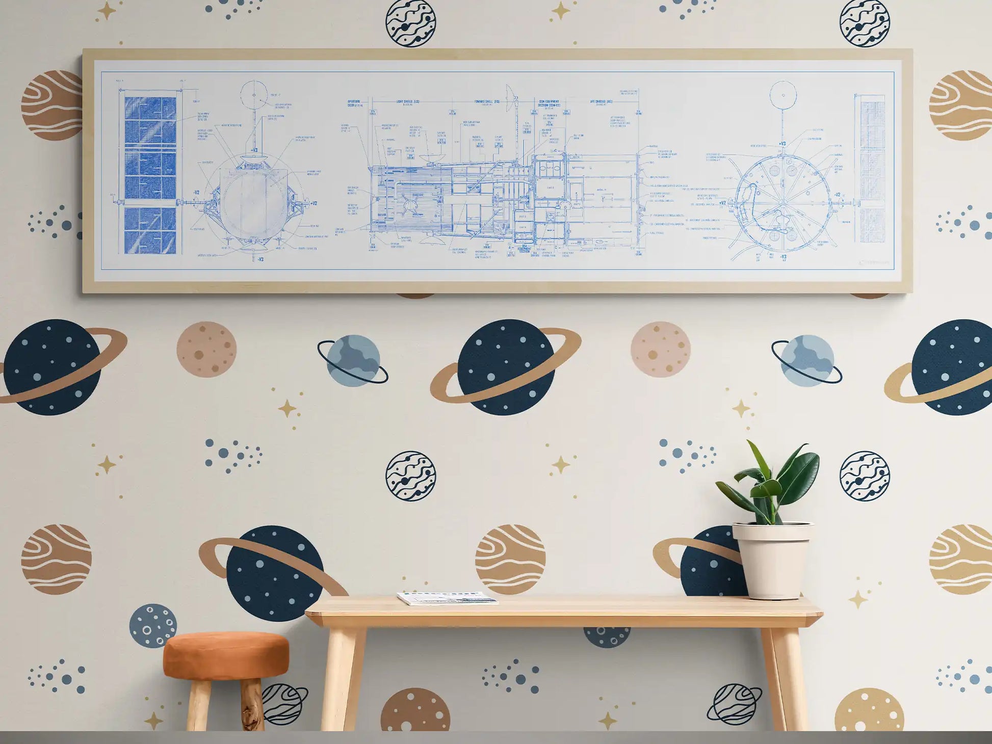 Hubble Space Telescope Blueprint | Rocket Blueprint Posters | The image shows a kids' playroom with a white-framed Hubble Space Telescope blueprint hanging on a space-themed wallpapered wall. The wallpaper is decorated with various planets and stars. Below, a light wood desk and an orange stool create a playful study area with a small plant adding a touch of greenery.