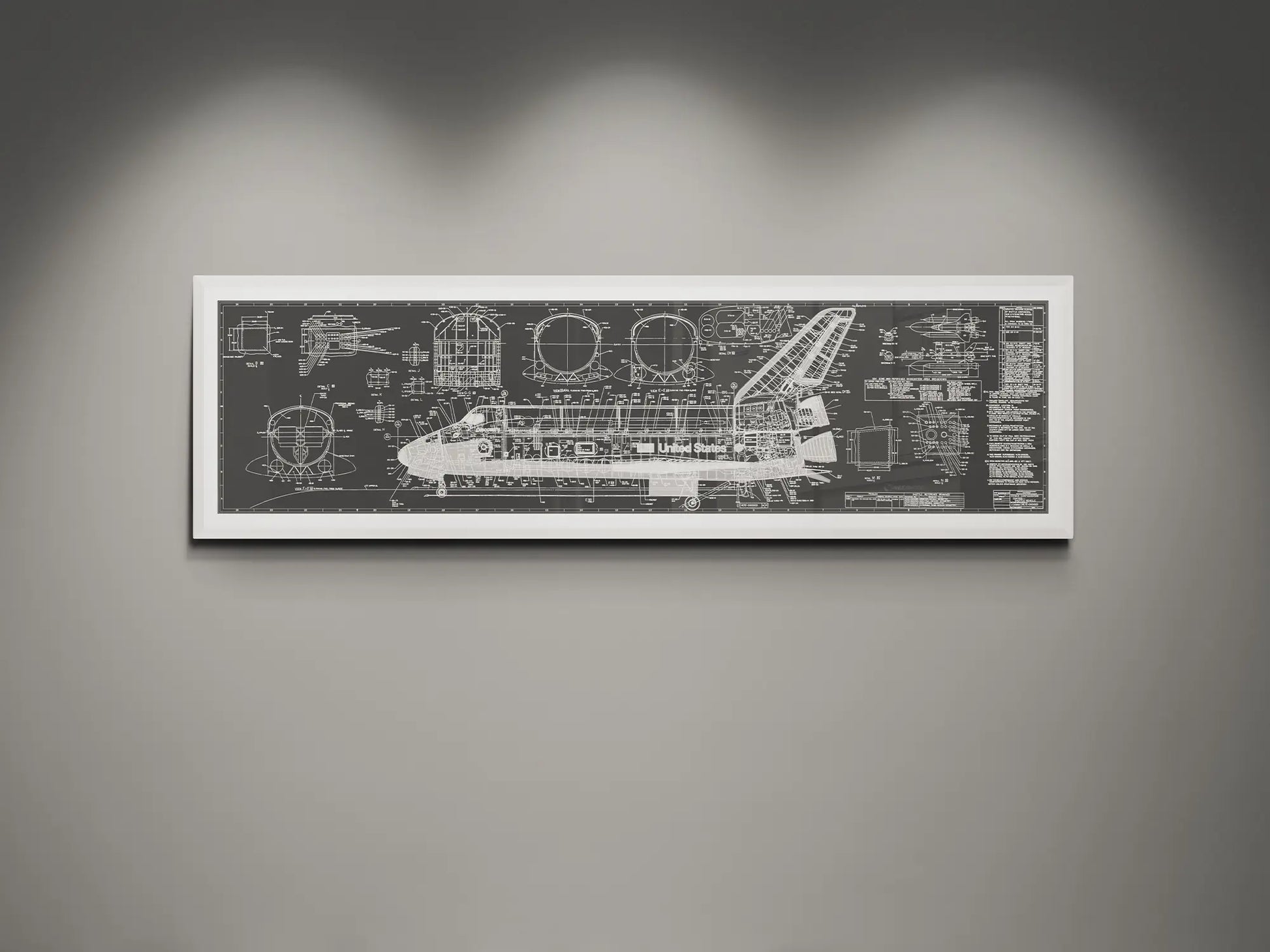 Framed NASA space shuttle blueprint wall art featuring detailed white engineering schematics and technical diagrams on a charcoal background, displayed on a modern gray wall.