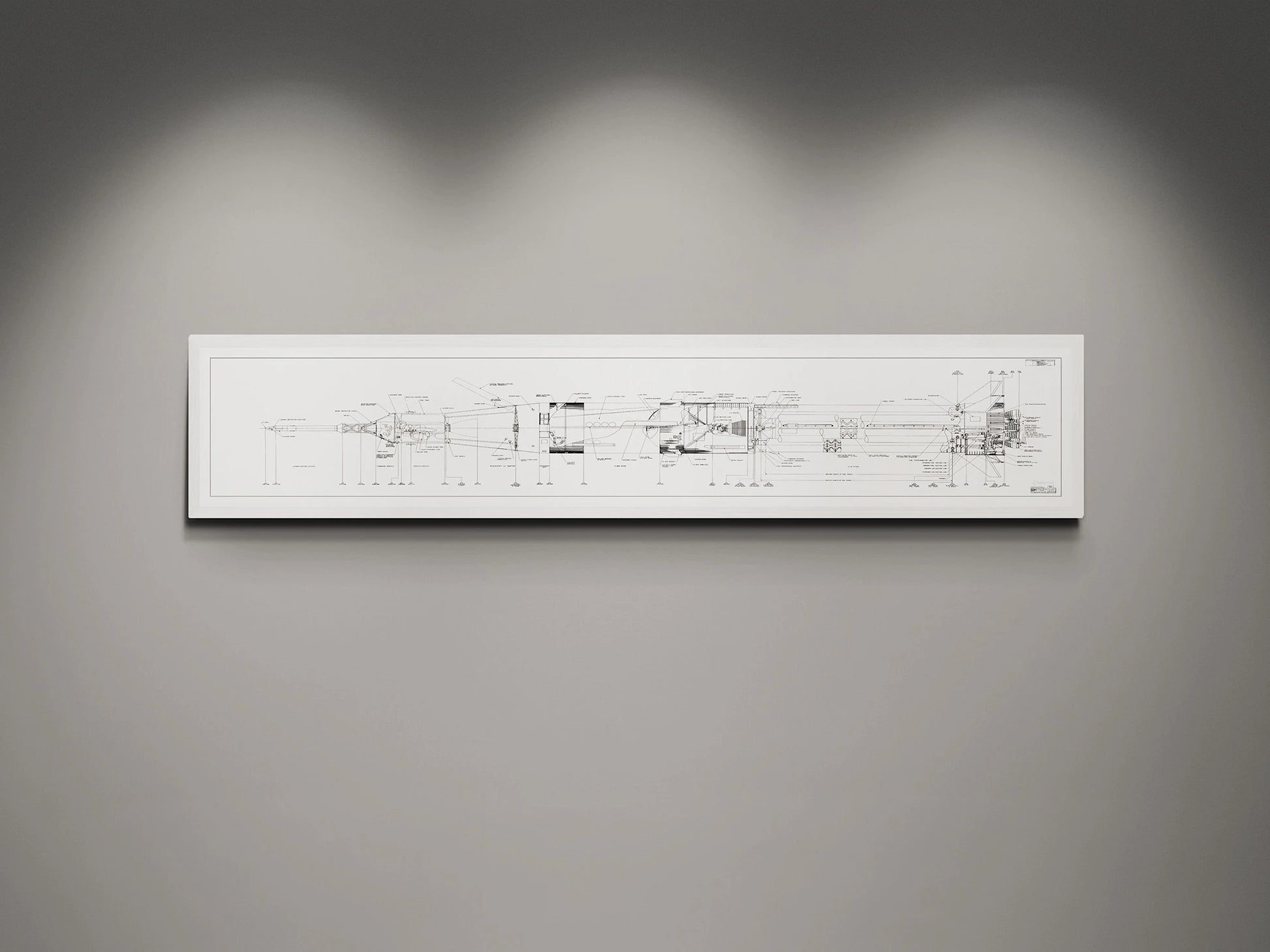 Apollo Saturn 1B Blueprint | NASA posters | Technical blueprint Diagram | A white-framed detailed blueprint of the NASA Saturn IB rocket, showcasing technical schematics in black on a white background. The blueprint is displayed on a gray wall, illuminated by soft overhead lights.