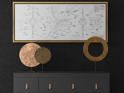 Voyager Space Probes Blueprint | Rocket Blueprint Posters | NASA | JPL | Contemporary interior featuring a black dresser with round metallic sculptures, one in copper and one in gold. Above, a white blueprint of the Voyager Probes, meticulously detailed in black ink, is framed in gold and mounted on a black wall.